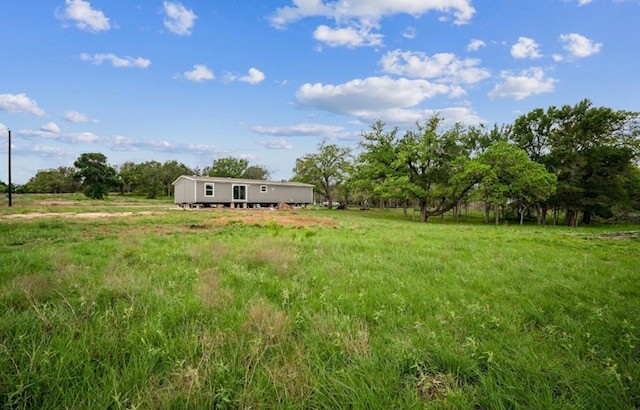 989 Ferguson Loop Dale Dale, TX 78616 - Photo 20 of 21 View of green lawn featuring a rural view