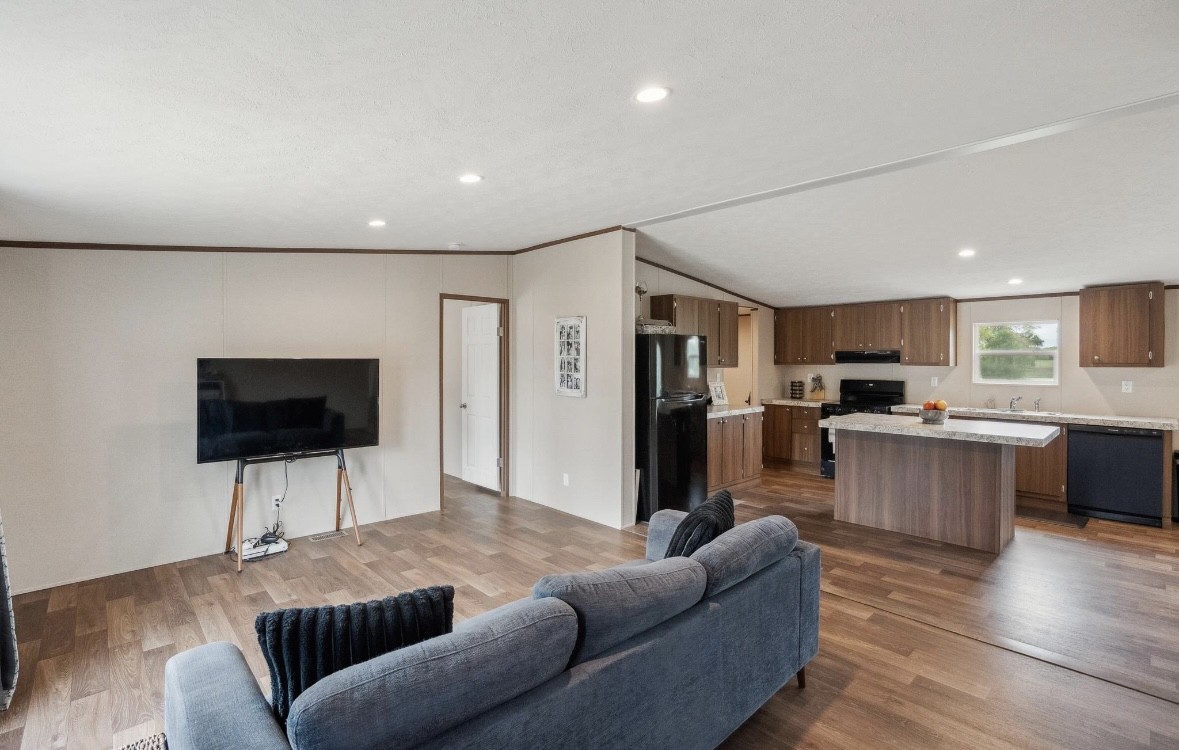 989 Ferguson Loop Dale Dale, TX 78616 - Photo 5 of 21 Living room with dark wood-style flooring, recessed lighting, and vaulted ceiling