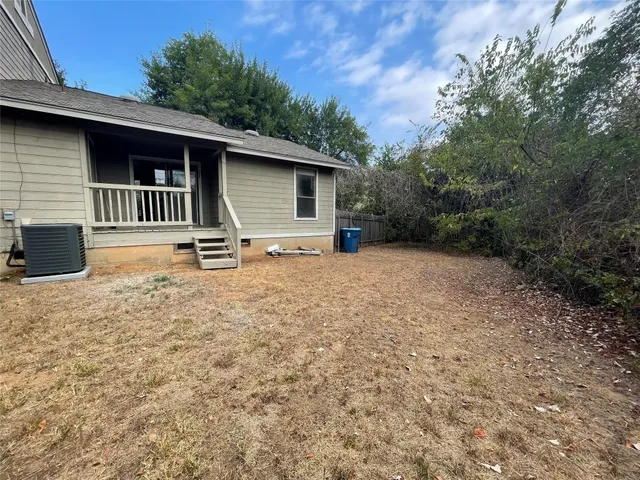 a backyard of a house with barbeque oven