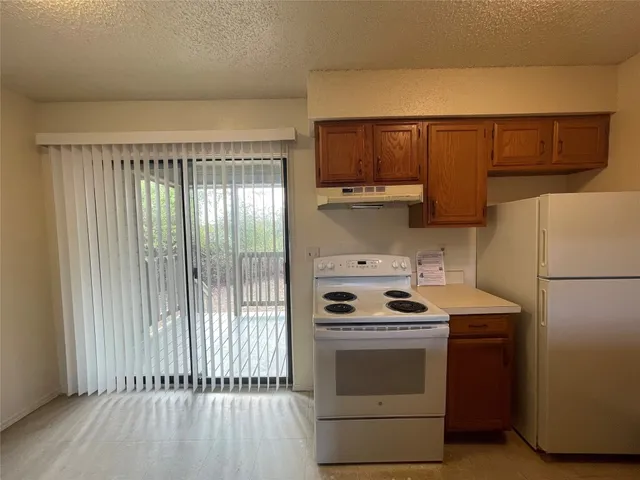 a kitchen with a white stove top oven and sink