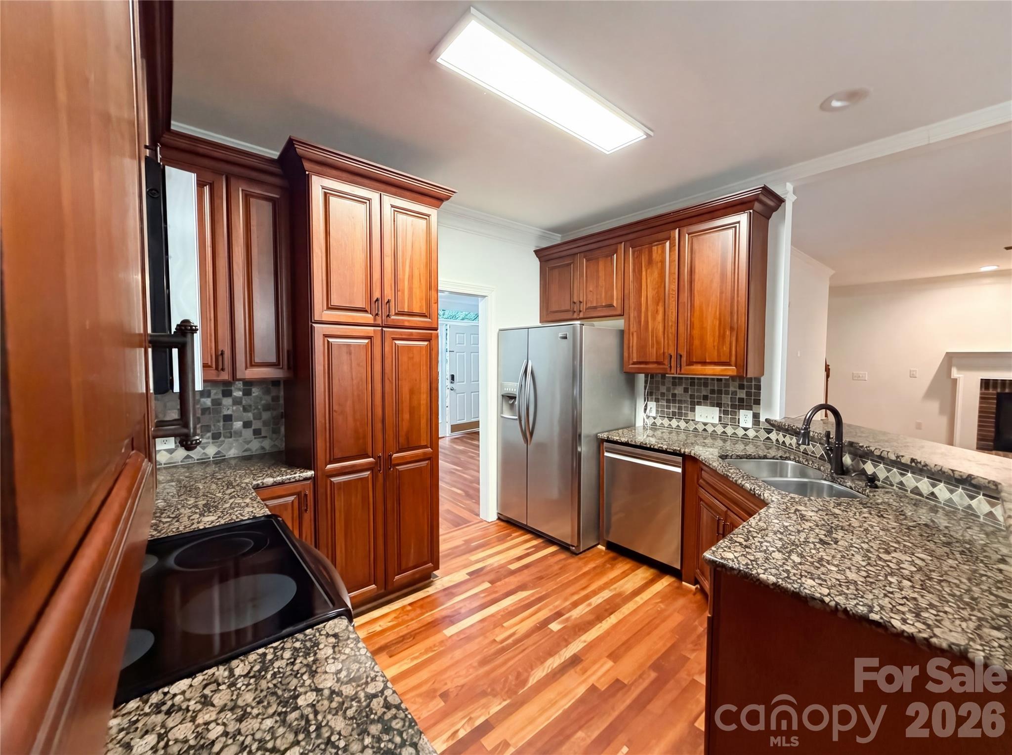 12341 Willingdon Road Huntersville, NC 28078 - Photo 2 of 17 a kitchen with granite countertop a refrigerator stove top oven sink and cabinets
