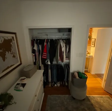 a view of walk in closet with clothes and shoes