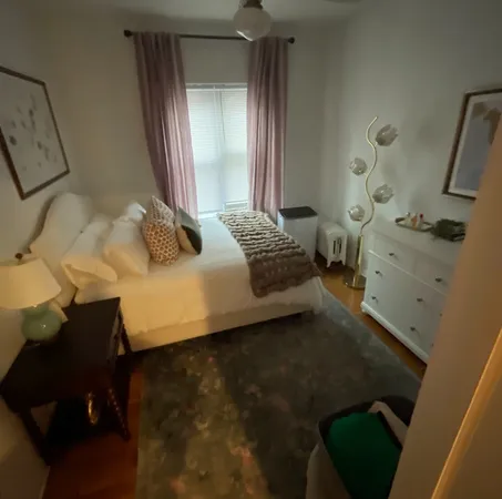 a bedroom with a bed and a dresser