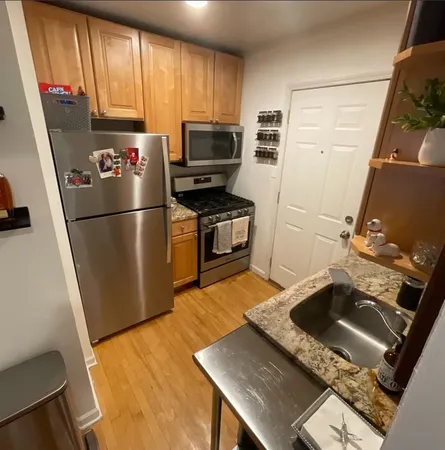 a kitchen with a sink appliances and cabinets