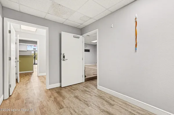 a view of empty room with wooden floor