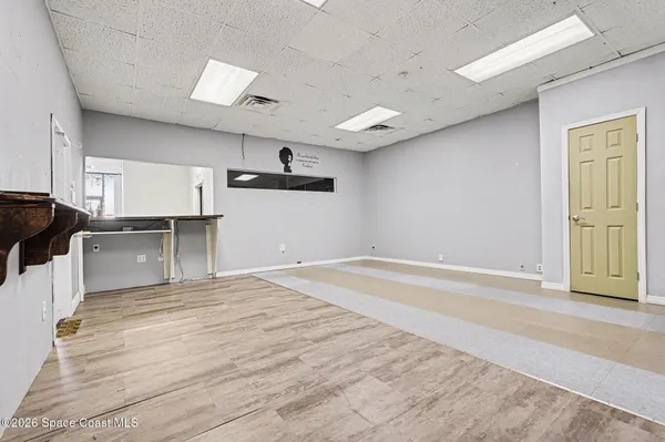 a view of kitchen with sink microwave and cabinets