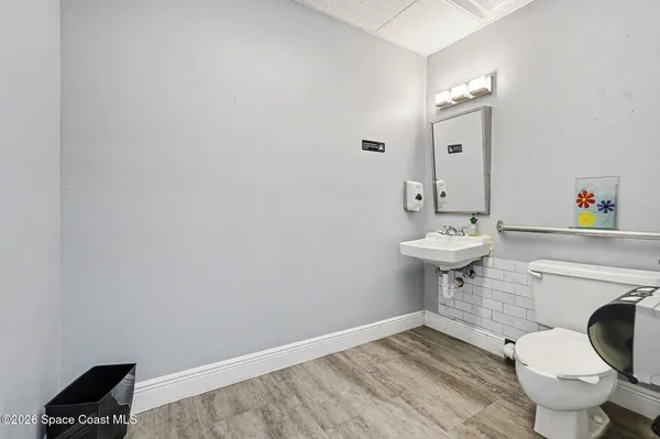 a bathroom with a sink toilet and a mirror