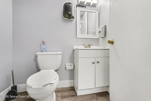 a bathroom with a toilet sink and mirror