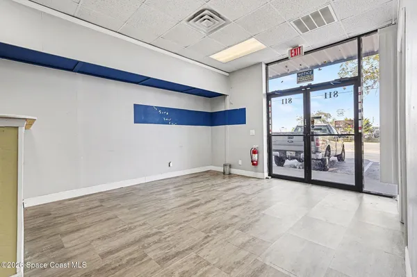 a view of an empty room with glass door
