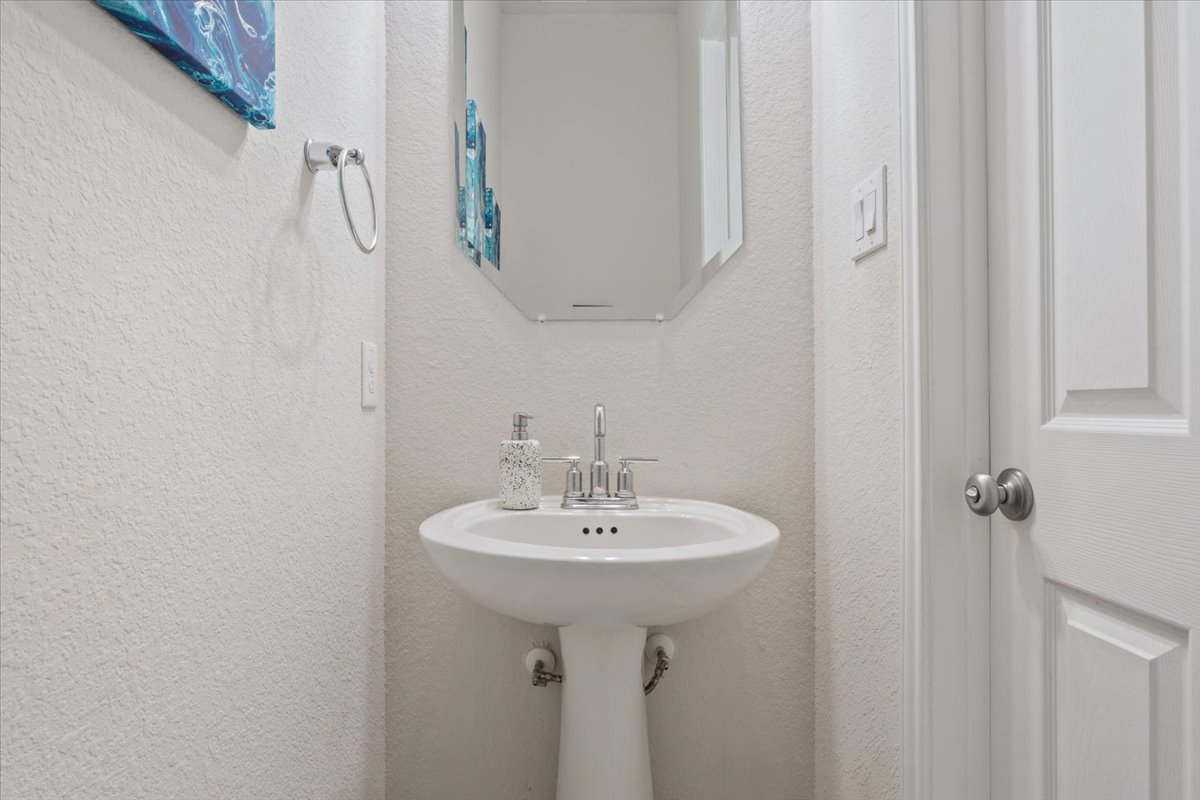 3625 Garrano Bend Leander, TX 78641 - Photo 22 of 38 A compact and functional pedestal sink graces this well-appointed powder room.