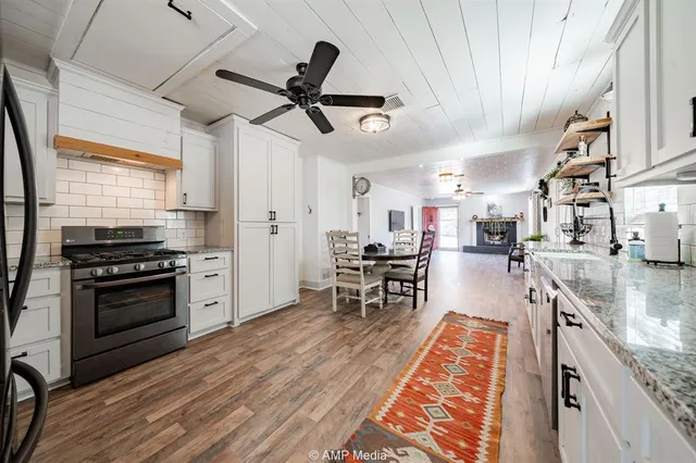 a kitchen with stainless steel appliances granite countertop a stove and a sink
