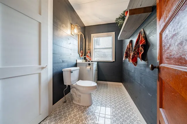 a bathroom with a toilet and a shower curtain