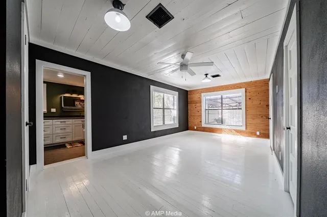 a view of an empty room with window and cabinet