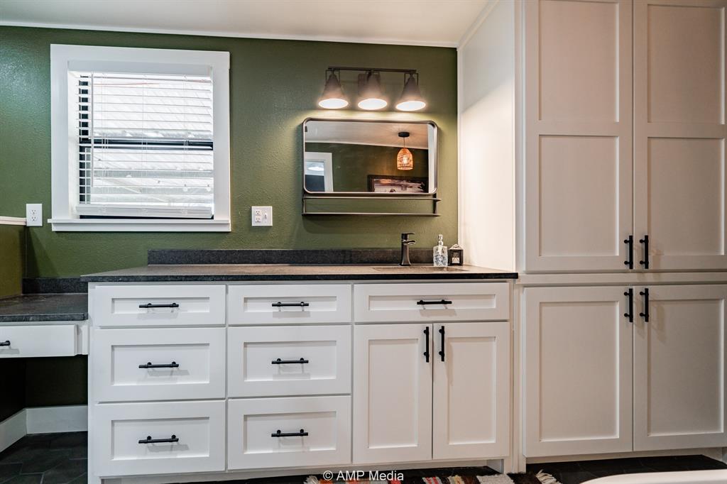 1002 Maple Street Stamford, TX 79553 - Photo 20 of 40 a bathroom with a sink and a mirror