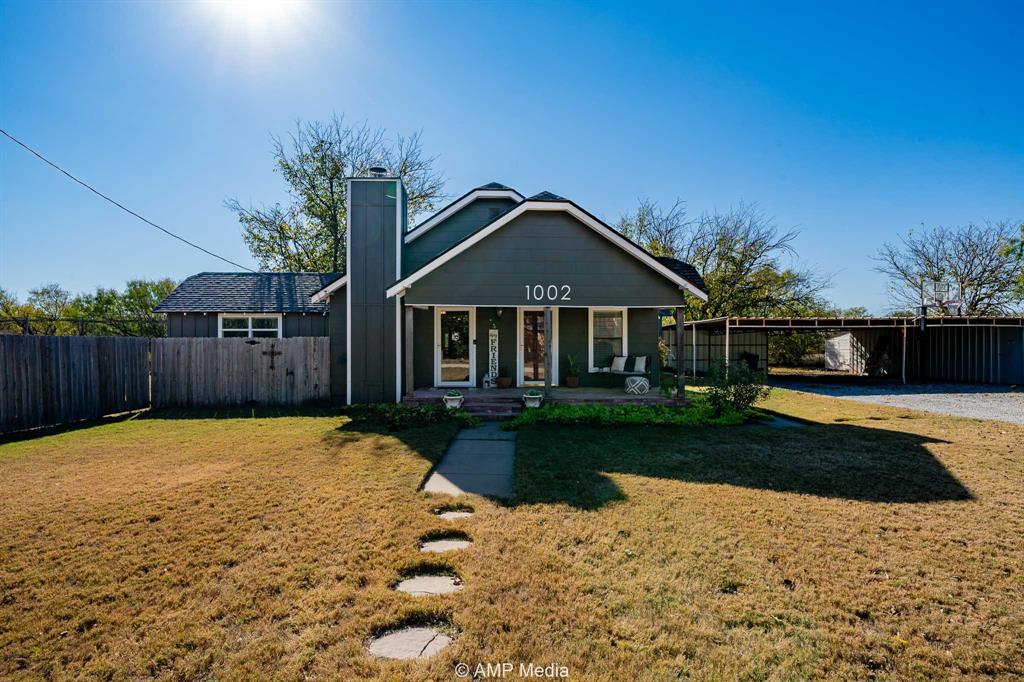 1002 Maple Street Stamford, TX 79553 - Photo 2 of 40 a front view of a house with a yard
