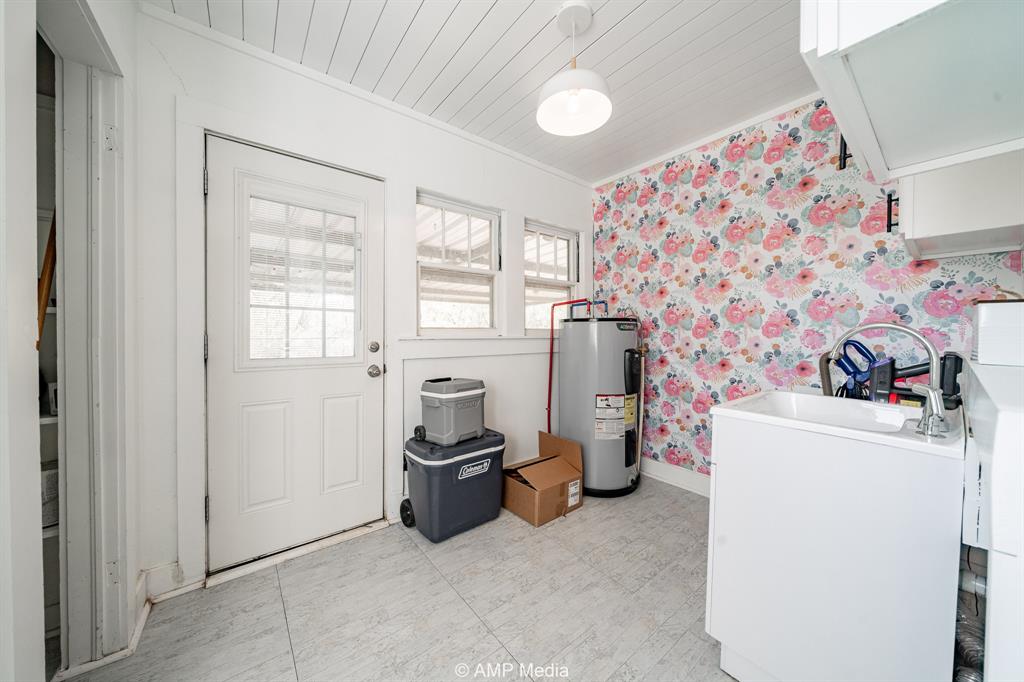 1002 Maple Street Stamford, TX 79553 - Photo 27 of 40 a view of a storage & utility room with a window