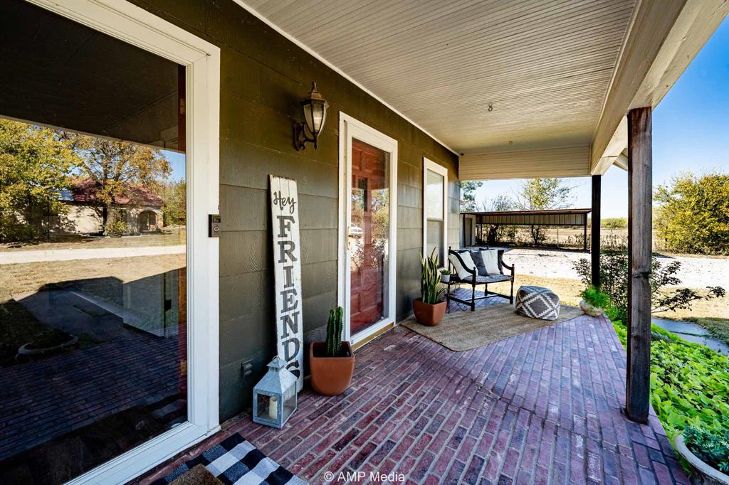 1002 Maple Street Stamford, TX 79553 - Photo 29 of 40 a view of a porch with wooden floor and outdoor space