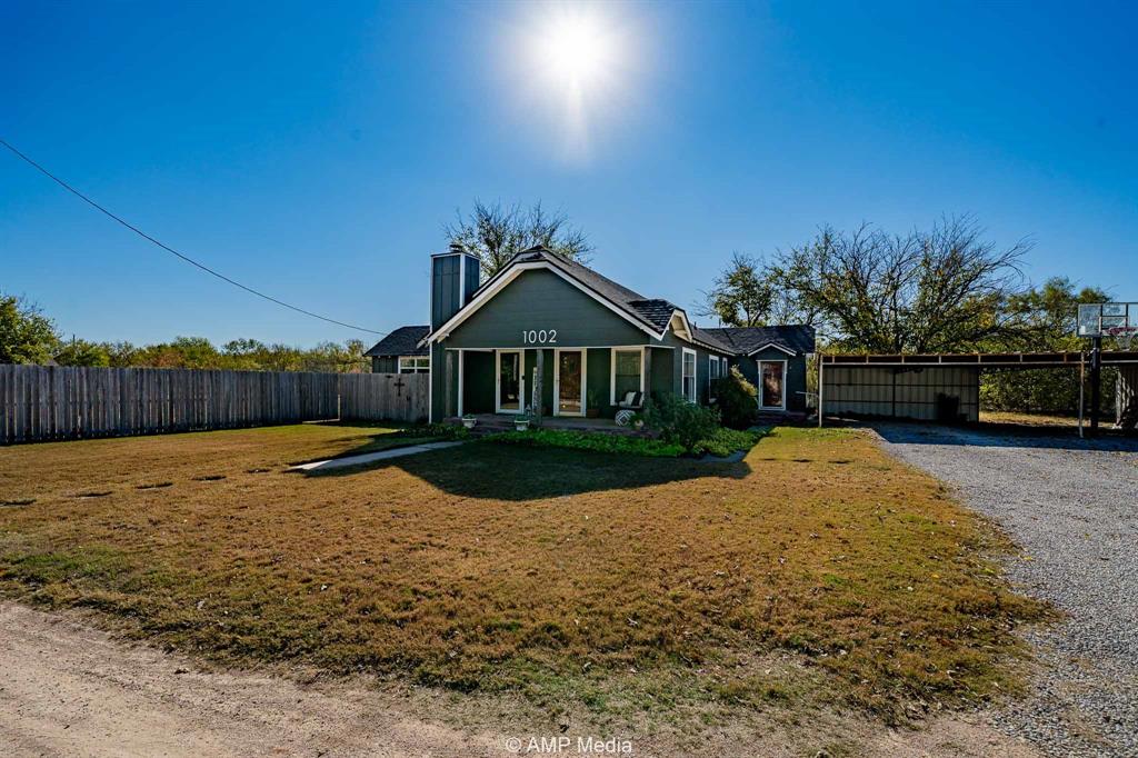 1002 Maple Street Stamford, TX 79553 - Photo 31 of 40 a swimming pool with wooden fence