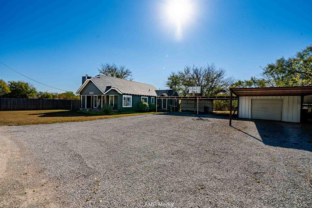 1002 Maple Street Stamford, TX 79553 - Photo 32 of 40 a front view of a house with a yard