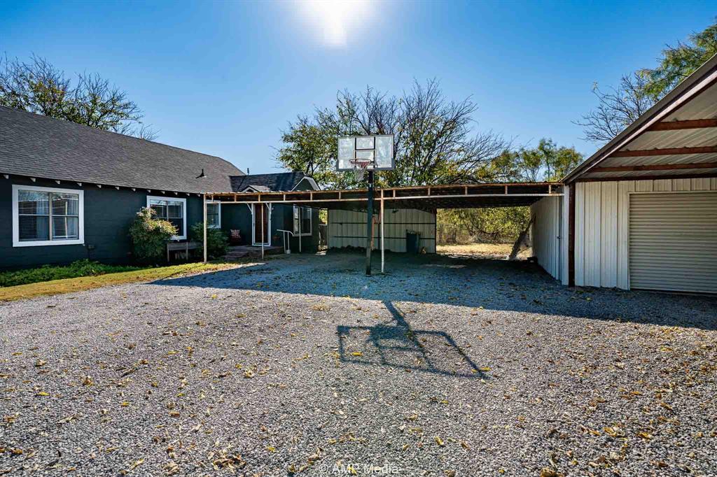 1002 Maple Street Stamford, TX 79553 - Photo 34 of 40 a view of a house with a yard
