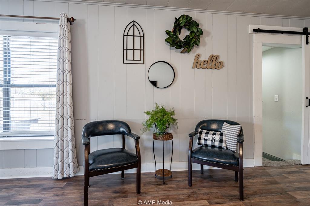 1002 Maple Street Stamford, TX 79553 - Photo 6 of 40 a view of a livingroom with furniture and wooden floor