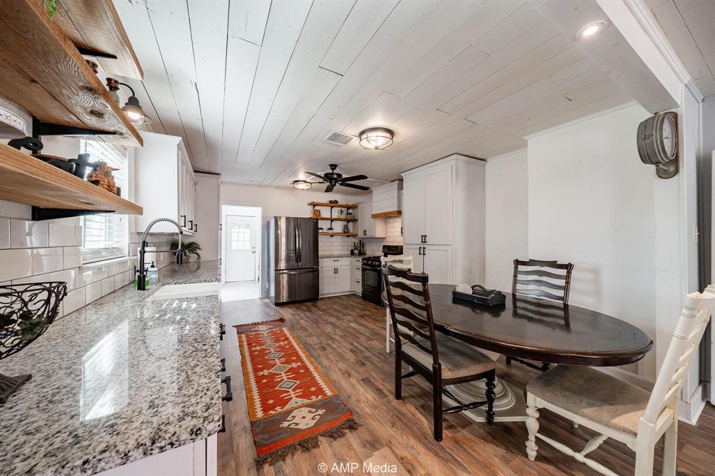 1002 Maple Street Stamford, TX 79553 - Photo 7 of 40 a view of a room with furniture and wooden floor