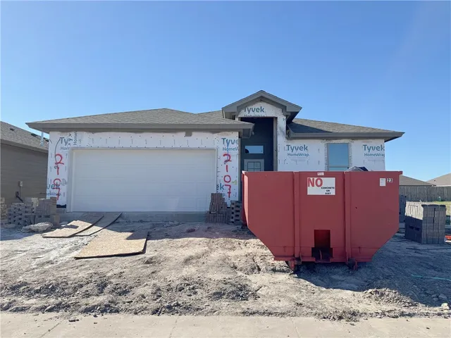 a view of a house with a wooden fence
