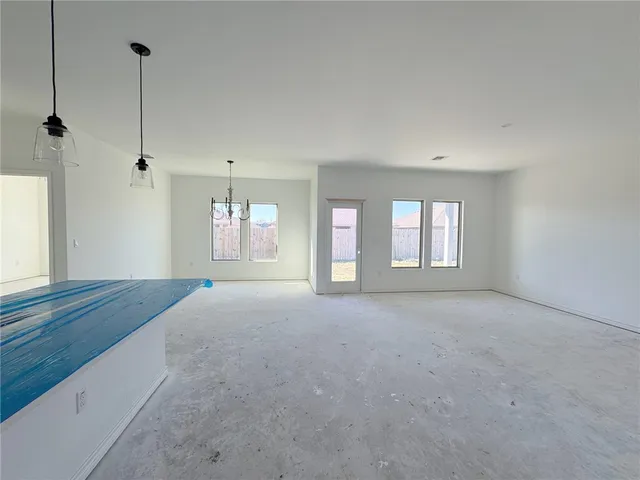 a kitchen with kitchen island a counter top space a sink a stove and cabinets