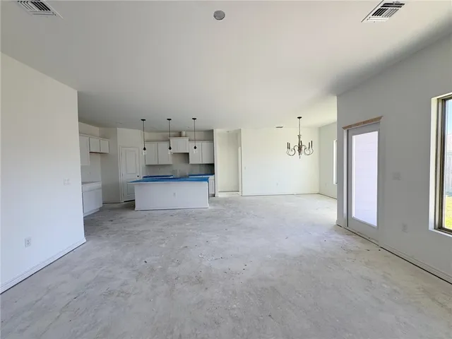 an empty room with windows and ceiling fan view