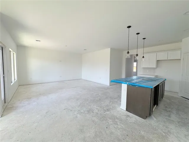 a view of a hallway to rooms