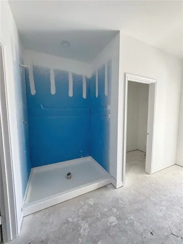 an empty room with a window and a ceiling fan