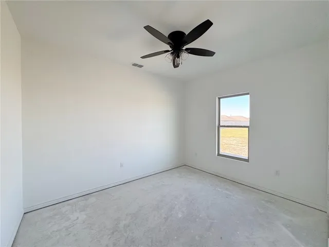 a view of a livingroom with a ceiling fan & window