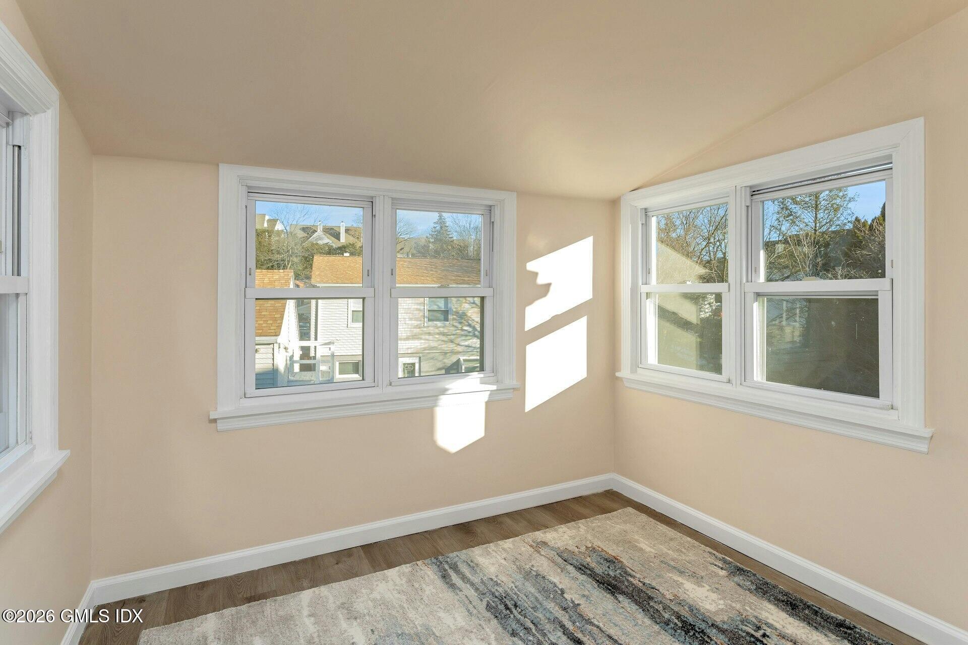 71 Prospect Street, Unit 2 Greenwich, CT 06830 - Photo 3 of 17 wooden floor in an empty room with a window