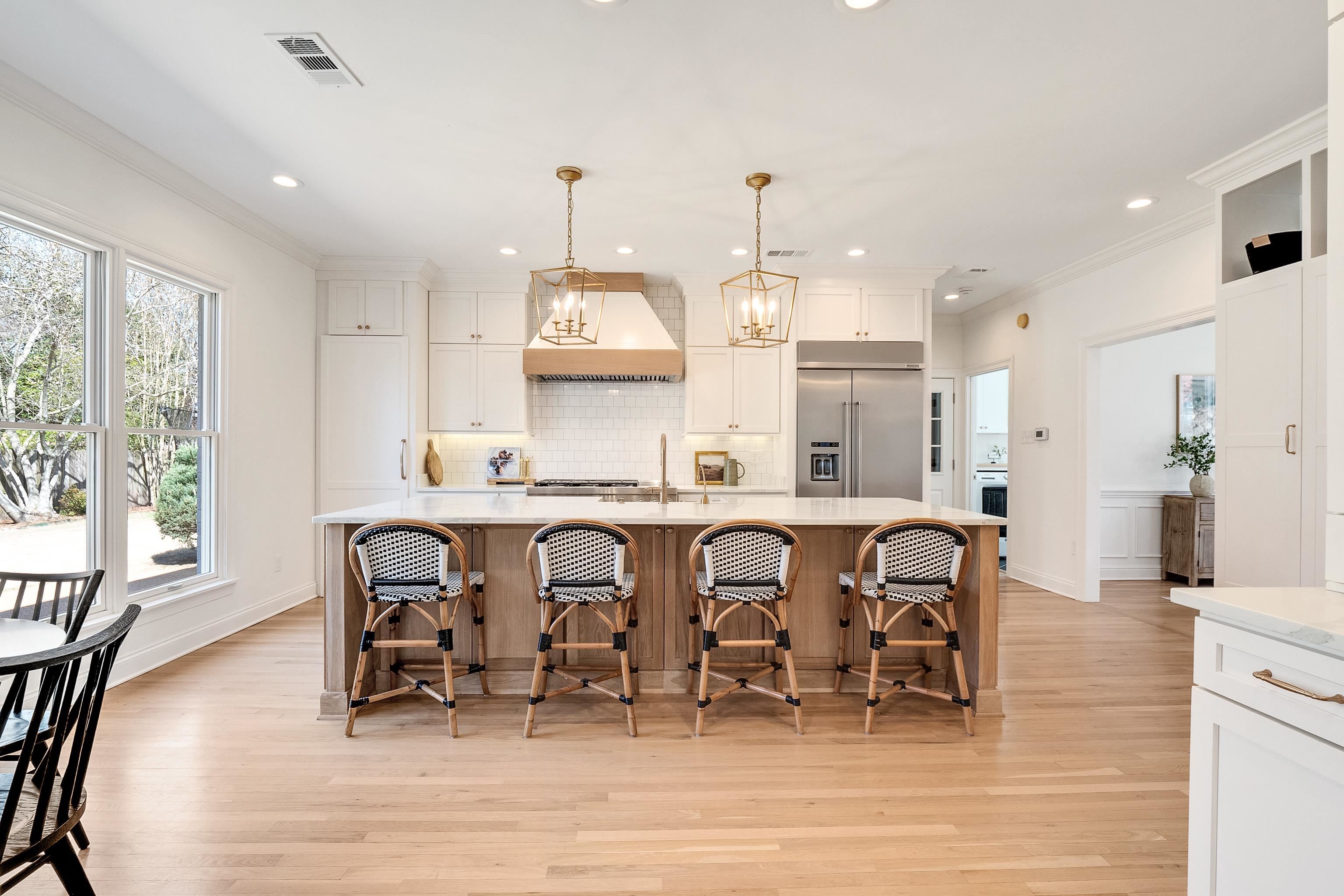 1870 Lonhill Drive Collierville, TN 38017 - Photo 9 of 34 a kitchen with stainless steel appliances kitchen island granite countertop a table chairs sink and cabinets