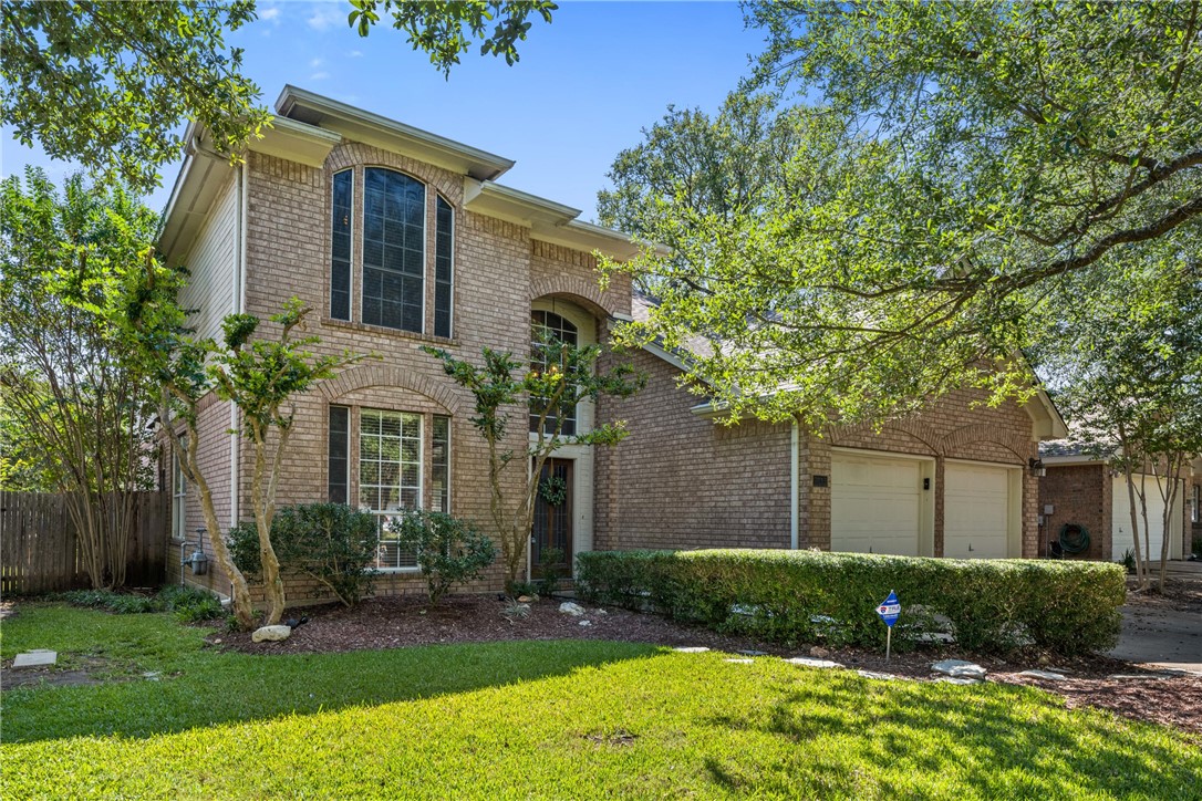 7113 Ridge Oak Road Austin, TX 78749 - Photo 1 of 1 a view of a brick house with a yard and plants and large tree