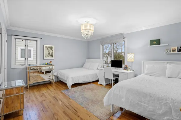 a bed room with a bed and a chandelier