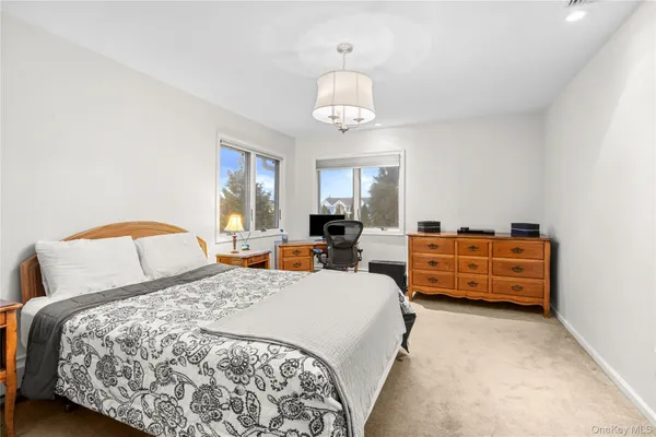 a bedroom with bed and a bookshelf