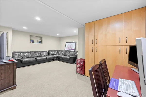 a front view of a house with a garden and trees