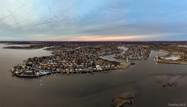 a front view of a house with a garden and plants