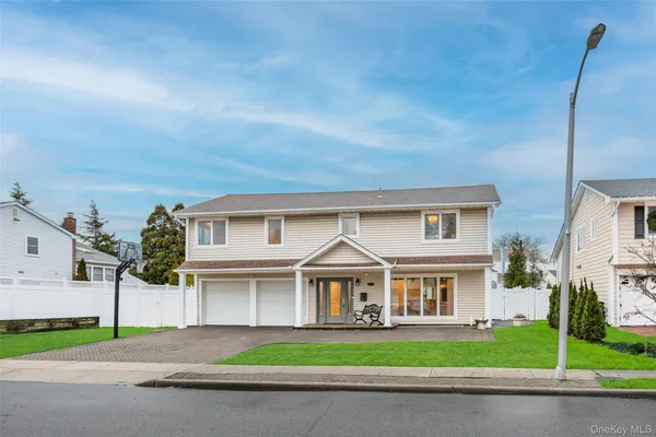 a view of house with backyard outdoor seating and green space