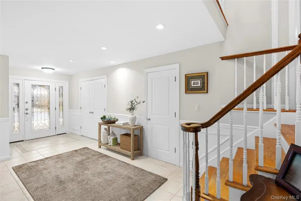 a view of a kitchen with furniture and a refrigerator