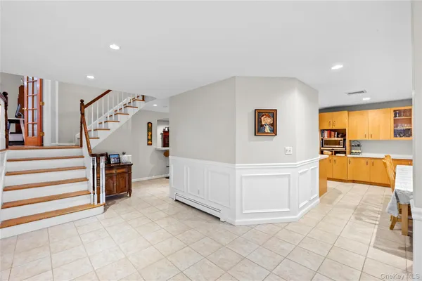 a view of a kitchen with kitchen island a large window cabinets and stainless steel appliances
