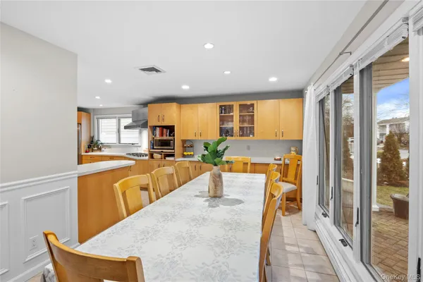 a large kitchen with a large counter top appliances and a dining table