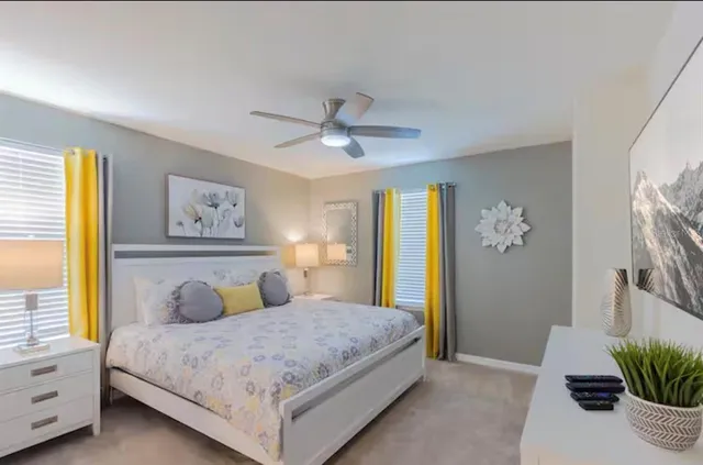 a bedroom with a large bed and a chandelier