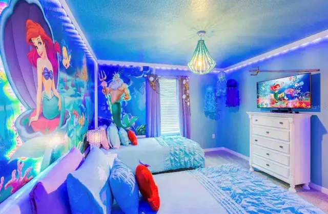 a bedroom with a bed and a chandelier