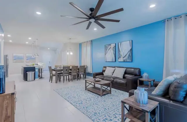a living room with furniture and kitchen view