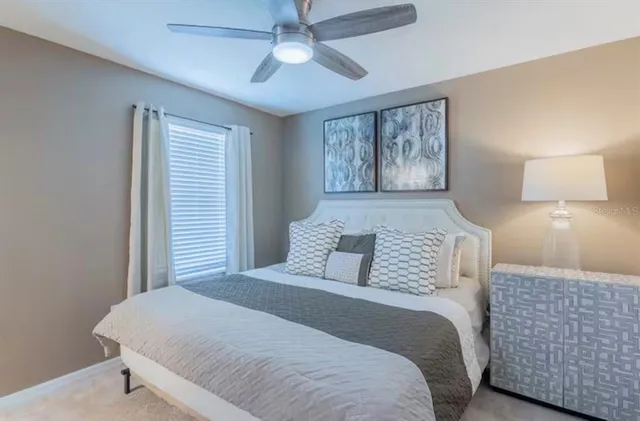 a bedroom with a large bed and a lamp