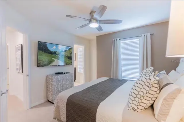 a bedroom with a bed and a flat screen tv