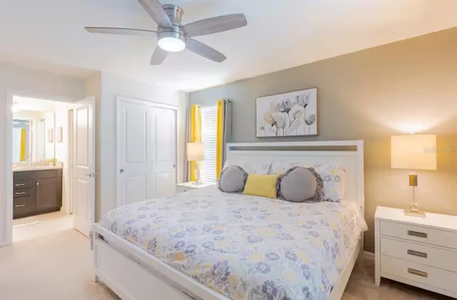 a bedroom with a large bed and a chandelier