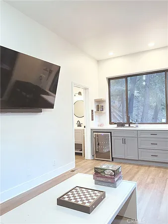 a kitchen with stainless steel appliances granite countertop a sink stove and white cabinets with wooden floor